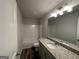 Bathroom with granite vanity, single sink, and tub/shower combo with neutral wall paint at 142 Tye St, Stockbridge, GA 30281