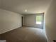 Carpeted bedroom featuring natural light from the window at 142 Tye St, Stockbridge, GA 30281