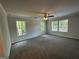 Expansive bedroom with a ceiling fan and multiple windows offering natural light and wooded views at 142 Tye St, Stockbridge, GA 30281