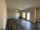 Bright and inviting living room featuring hardwood floors, neutral walls, a ceiling fan, and a fireplace at 142 Tye St, Stockbridge, GA 30281