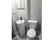 Modern half bathroom featuring a sleek pedestal sink and toilet in a compact space at 4814 Glenwood Rd, Decatur, GA 30035