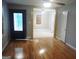 Inviting living room featuring hardwood floors, an open layout, and a front door with decorative glass at 4814 Glenwood Rd, Decatur, GA 30035
