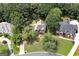 Aerial view showcases the home's roof, yard, and surrounding trees at 170 Glen Eagle Way, Mcdonough, GA 30253