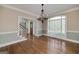 Elegant dining room with hardwood floors, chandelier, and large windows at 170 Glen Eagle Way, Mcdonough, GA 30253