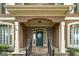 Elegant front door with stone accents, flanked by windows at 170 Glen Eagle Way, Mcdonough, GA 30253