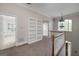 Hallway features white railings, built-in shelving, and natural lighting at 170 Glen Eagle Way, Mcdonough, GA 30253