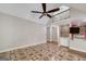 Bright living room with vaulted ceilings, fan, and connecting kitchen area at 170 Glen Eagle Way, Mcdonough, GA 30253