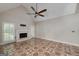 Spacious living room features a fireplace, ceiling fan, and decorative tiled floor at 170 Glen Eagle Way, Mcdonough, GA 30253