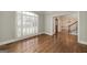 Bright living room featuring hardwood floors and plantation shutters at 170 Glen Eagle Way, Mcdonough, GA 30253