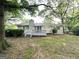 View of a ranch style home's backyard with a wooden deck and a partial brick chimney at 1918 Leigh Sw Dr, Conyers, GA 30094