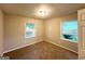 Bedroom featuring neutral paint and carpet, two windows, and a ceiling fan at 1918 Leigh Sw Dr, Conyers, GA 30094