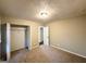 Neutral bedroom with carpet floors, closet, and view to another room at 1918 Leigh Sw Dr, Conyers, GA 30094