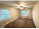 A cozy bedroom with neutral walls, plush carpet, and natural light at 1918 Leigh Sw Dr, Conyers, GA 30094