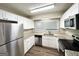 Kitchen with stainless steel appliances, granite countertops, and white cabinets at 1918 Leigh Sw Dr, Conyers, GA 30094