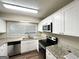 A kitchen with granite countertops, wood floors, stainless steel appliances, and white cabinets at 1918 Leigh Sw Dr, Conyers, GA 30094