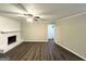 Open living room featuring a painted brick fireplace, and modern flooring at 1918 Leigh Sw Dr, Conyers, GA 30094