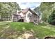 Beautiful backyard featuring large home with screened in porch and outdoor deck at 235 Ashley Forest Dr, Fayetteville, GA 30214