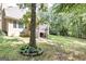 The home's backyard features a screened porch, mature trees, and a well-manicured lawn at 235 Ashley Forest Dr, Fayetteville, GA 30214