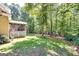 Large backyard features a screened porch and mature trees providing shade and privacy at 235 Ashley Forest Dr, Fayetteville, GA 30214