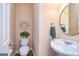 Well-maintained powder room with decorative mirror and fixtures at 235 Ashley Forest Dr, Fayetteville, GA 30214
