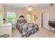 Guest bedroom with bright windows, light walls, and a floral patterned bedspread at 235 Ashley Forest Dr, Fayetteville, GA 30214