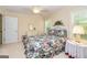 Bright bedroom with a floral comforter, comfortable furniture, and natural light at 235 Ashley Forest Dr, Fayetteville, GA 30214