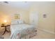 Cozy bedroom featuring a floral patterned bedspread, neutral carpet, and bright windows at 235 Ashley Forest Dr, Fayetteville, GA 30214