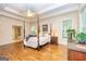 Spacious bedroom featuring a four-poster bed, hardwood floors, and ensuite bathroom access at 235 Ashley Forest Dr, Fayetteville, GA 30214