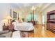 Bright bedroom with a four-poster bed, hardwood floors, sitting area, and natural light at 235 Ashley Forest Dr, Fayetteville, GA 30214