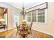 Bright dining area features hardwood floors, chandelier, and large windows at 235 Ashley Forest Dr, Fayetteville, GA 30214