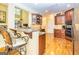 This open kitchen offers granite countertops, breakfast bar and hardwood floors throughout at 235 Ashley Forest Dr, Fayetteville, GA 30214