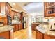 Open kitchen with stainless steel appliances, granite countertops, and hardwood floors at 235 Ashley Forest Dr, Fayetteville, GA 30214