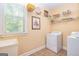 Functional laundry room with utility sink and washer/dryer at 235 Ashley Forest Dr, Fayetteville, GA 30214