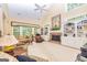 Spacious living room with fireplace, built-in shelving and large windows providing natural light at 235 Ashley Forest Dr, Fayetteville, GA 30214