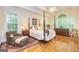 Bright main bedroom with hardwood floors and large windows at 235 Ashley Forest Dr, Fayetteville, GA 30214