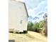 View of the home from the side angle, showing the spacious yard and surrounding trees at 413 Atlas Ct, Locust Grove, GA 30248