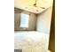 Bedroom features a ceiling fan and a window with blinds allowing natural light into the space at 413 Atlas Ct, Locust Grove, GA 30248
