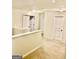 Upstairs hallway featuring neutral carpet and multiple doorways, showcasing the home's layout at 413 Atlas Ct, Locust Grove, GA 30248