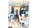 Eat-in kitchen featuring grey cabinets, wood-look floors, stainless appliances, and a circular table at 413 Atlas Ct, Locust Grove, GA 30248