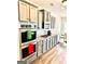 Kitchen featuring light grey cabinets, stainless appliances, and a breakfast nook with modern table and chairs at 413 Atlas Ct, Locust Grove, GA 30248