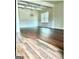 Living room featuring hardwood floors, a coffered ceiling, wainscoting, and lots of natural light at 413 Atlas Ct, Locust Grove, GA 30248