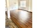Bright living room featuring hardwood floors, wainscoting, and large windows for natural light at 413 Atlas Ct, Locust Grove, GA 30248