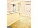 Open upstairs loft area featuring neutral carpet, white walls, and multiple doorways to bedrooms at 413 Atlas Ct, Locust Grove, GA 30248