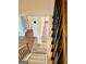 View of staircase featuring wood stairs, modern iron railing, and wood-look landing on second floor at 413 Atlas Ct, Locust Grove, GA 30248