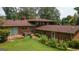 A sprawling backyard features a patio, mature trees, lush greenery, and seamless indoor-outdoor flow at 6214 Crestview Se Dr, Covington, GA 30014