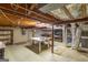 A spacious basement area with unfinished ceilings, a work table, and shelving for storage at 6214 Crestview Se Dr, Covington, GA 30014