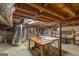 A well-lit basement featuring exposed wooden beams and ductwork, perfect for future customization at 6214 Crestview Se Dr, Covington, GA 30014