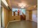 Finished basement with stairs leading up to kitchen and light green tile flooring at 6214 Crestview Se Dr, Covington, GA 30014