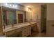 Bright bathroom featuring double sinks with white countertops and vanity mirror at 6214 Crestview Se Dr, Covington, GA 30014