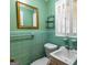 Bathroom with window, a mirror, tiling, sink, and toilet at 6214 Crestview Se Dr, Covington, GA 30014